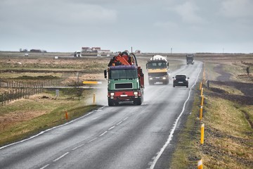 Fototapeta na wymiar Truck traffic on the main road in Iceland after rain, wet asphalt surface