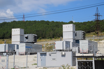 Power substation equipment, transformers and wire poles.