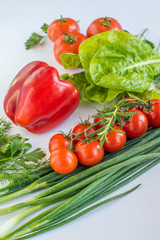 different types of vegetables on a white background top view. vegan products. peppers, cabbage, tomatoes, cucumbers, various herbs. vegetable diet.