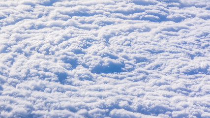 White cumulus clouds on clear blue sky background closeup