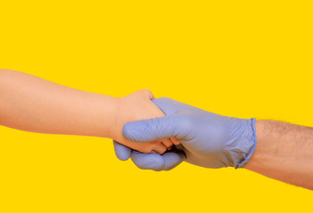 Fototapeta premium Minimal composition with handshake on yellow background