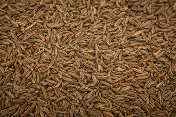 Surface covered with cumin seeds as a backdrop texture composition