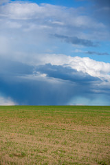 Fototapeta na wymiar Dark clouds over field before a tunderstorm
