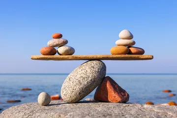 Foto op Canvas Symbolic scales of the stones against the sea. Pros and cons concept © Aleksandr Simonov