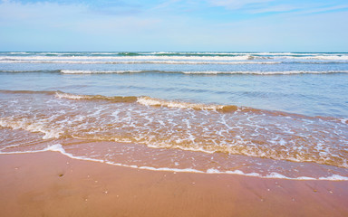 Seashore at sunset in the Mediterranean Sea. Waves beating on the beach