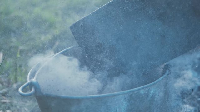 Pouring ashes off shovel into metal bucket fire damage slow motion