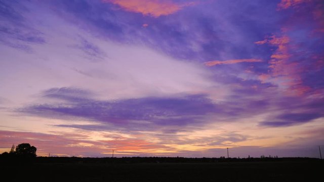 wide angle panoramic and dynamic pink misty sunrise timelapse with cool purple clouds and colour change