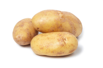 Several potato tubers on a white isolated background. Fresh vegetables. Yellow potatoes.