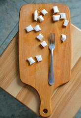 lard cut on a wooden board with fork