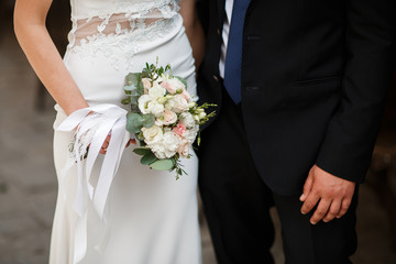 Beautiful wedding couple holding hands and flowers. It's such an exciting moment. Vintage wedding dress and men's costume. Advertising for wedding salon. Wedding banner.horizontal