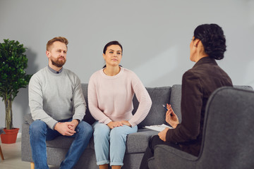 Family psychologist. Female psychologist at a psychotherapy session with family in the office.