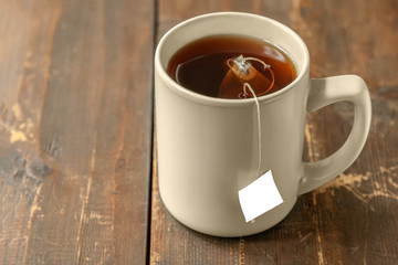 mug of tea in a bag on a wooden table