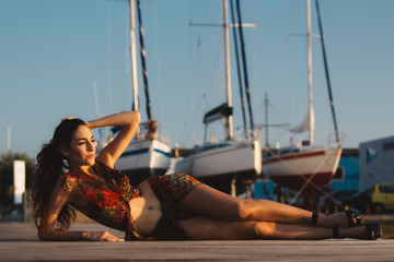 Girl in a beach suit in front of boat