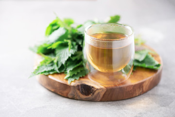 Cup of healthy herbal tea with nettle. Alternative herbal medicine. Stinging nettles, urtica. Skin...