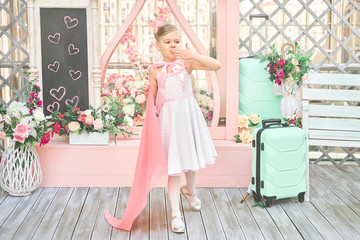 Fototapeta premium nice little girl blows a kiss. the child meets the passenger