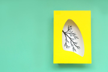 Lungs symbol paper art, turquoise and yellow. World tuberculosis day. Health care, medicine, lung cancer, internal donor organ and stop smoking campaign. Copy space.