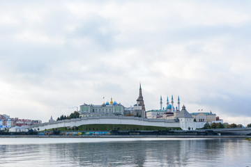 Fototapeta premium View of the Kazan Kremlin with Presidential Palace, Annunciation Cathedral, Soyembika Tower, Qolsharif Mosque from the embankment. The cloudy day.