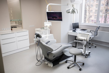 Modern Dental Clinic, Dentist chair and other accessories used by dentists in medical light. Dental surgeon, is a surgeon . Dentist's office. Dental equipment in modern, clean interior