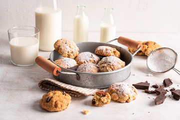 Chocolate chip cookies with milk bottles on white background