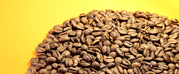 Coffee beans on a yellow background at the bottom.