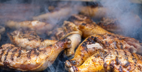 chicken drumsticks on charcoal grill close up photo
