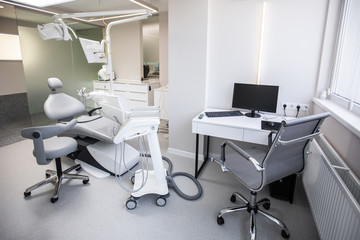 Modern Dental Clinic, Dentist chair and other accessories used by dentists in medical light. Dental surgeon, is a surgeon . Dentist's office. Dental equipment in modern, clean interior