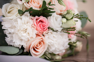 Perfect image with copy space for chic boho wedding magazines and websites, bohemian, fashion, florist. Flowers bouquet with nude roses and wedding rings. Copy space. Flowers background.