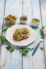 octopus carpaccio with potatoes green olives capers and pesto sauce