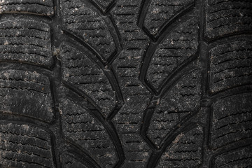 Fototapeta na wymiar Dirty winter tire tread. Close up