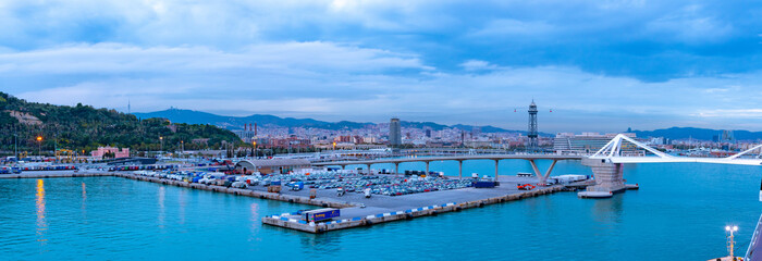 Barcelona, Spain. Panorama of Porta d’Europa bridge over Barcelona Port and Wharfs, with Torre...