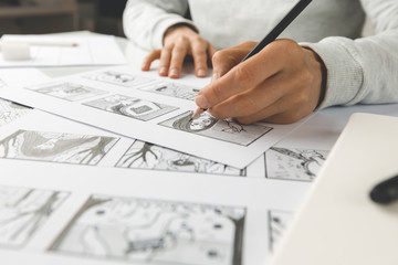 The hands of an illustrator painter draw a storyboard for a movie or cartoon. - 352645677