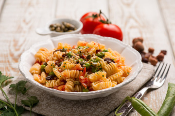 pasta with fresh tomatoes green peas capers and hazelnuts