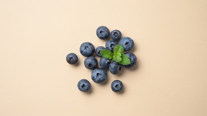 fresh juicy blueberries with mint scatter  on a yellow  background