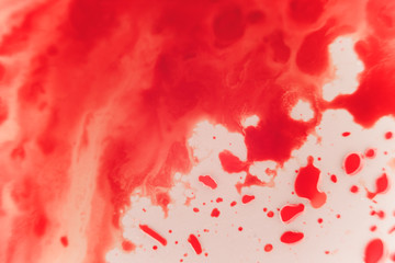 Fresh red blood splat on white porcelain with specks from the impact. Copy space area for horror...