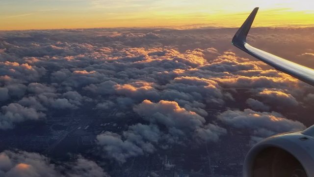 Early morning flight at relatively low altitude over lower stratus clouds.