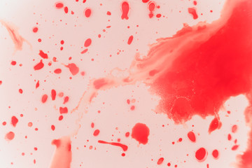 Fresh red blood splat on white porcelain with specks from the impact. Copy space area for horror...