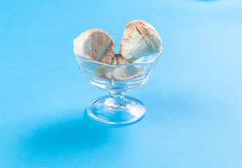 Three balls of ice cream in a glass vase