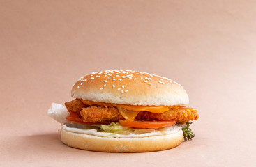 classic burger with chicken on a brown background