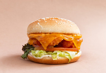 classic burger with chicken on a brown background