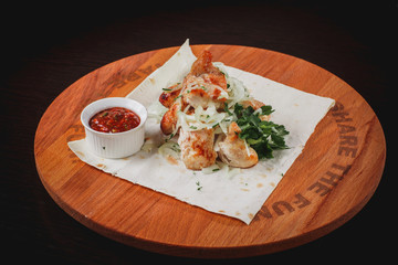chicken breast skewer on a Board with sauce