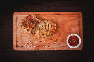 Grilled chicken thighs on a Board