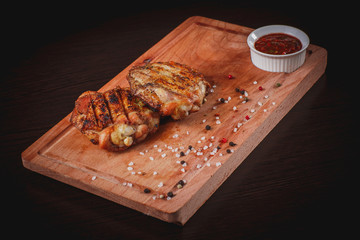 Grilled chicken thighs on a Board