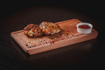 Grilled chicken thighs on a Board