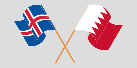 Crossed and waving flags of Iceland and Bahrain