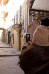 Girl takes a picture of the city in the winter