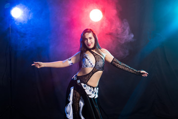 Fototapeta premium Spirituality dance. Beautiful sexy woman with luxury glossy eastern make-up dancing tribal fusion. Belly dance.
