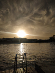 handrails for descent into the sea at sunset