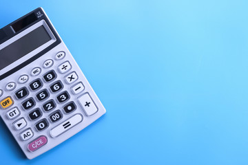 Calculator keypad on a blue background. Top view. Copy space