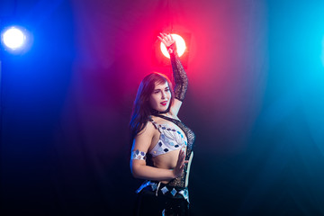 Young woman dancing in Tribal Fusion style. Belly dance on the stage. Copy space.