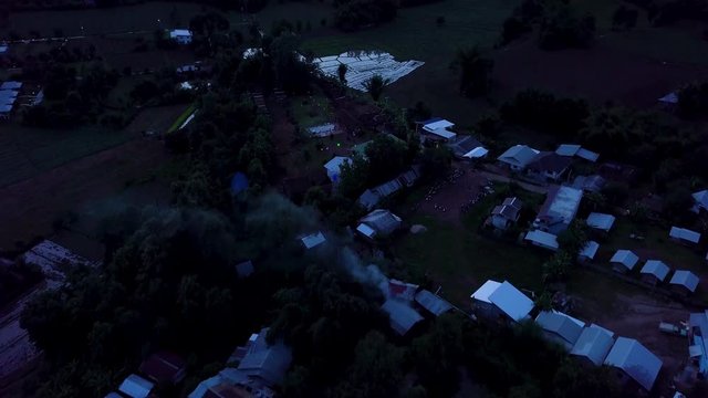 Aerial Revealing Local Homes and Landscape in Pi, Thailand after Sunset